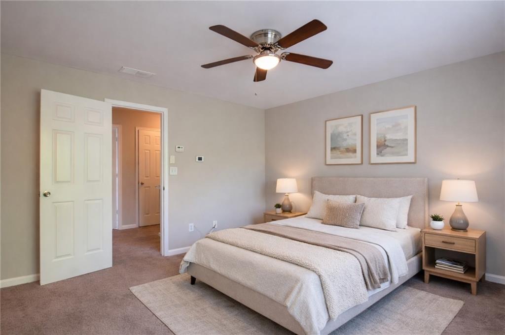 6764 Blackstone Place, Unit 6 Mableton, GA 30126 - Photo 3 of 5 a bedroom with a large bed and a ceiling fan