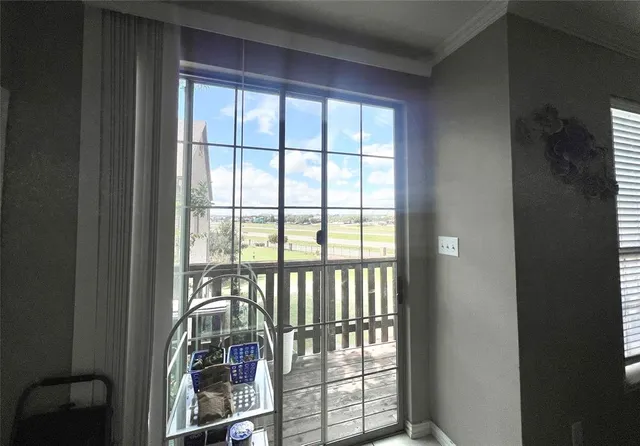 a view of a porch with a table and chairs