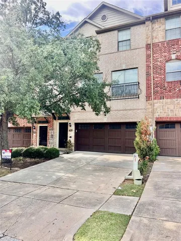 a front view of a house with a garden and plants