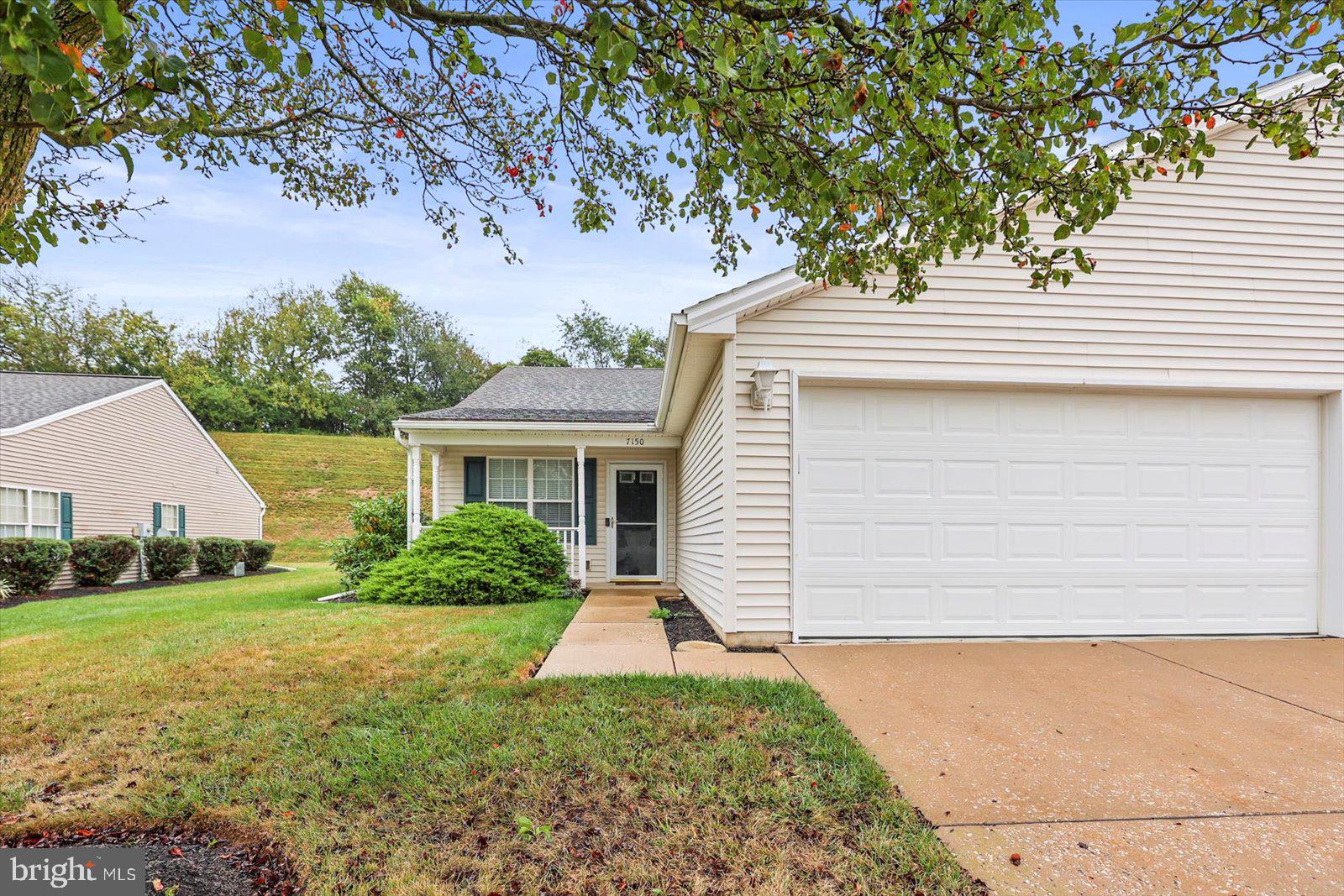 7150 Seneca Ridge Drive York, PA 17403 - Photo 1 of 32 a front view of a house with garden
