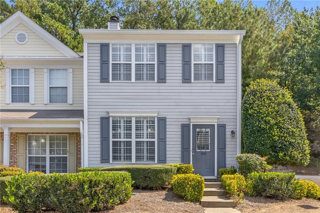 1005 Whitestone Ridge Alpharetta, GA 30005 - Photo 1 of 1 a view of a brick house with large windows and a large tree