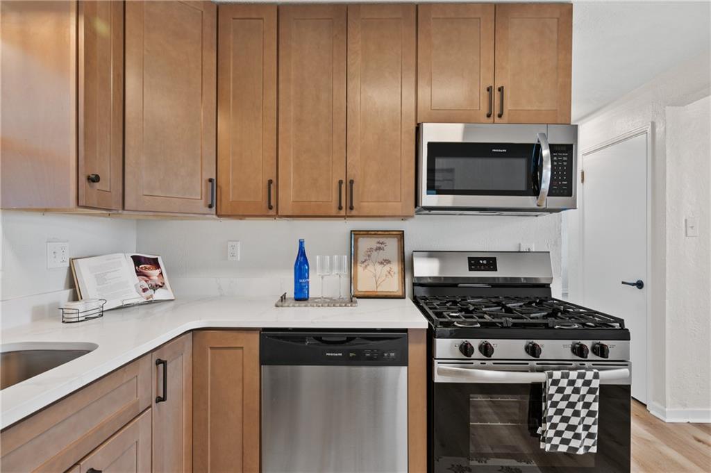 3593 Middleboro Road Pittsburgh, PA 15234 - Photo 6 of 20 a kitchen with cabinets stainless steel appliances and a sink