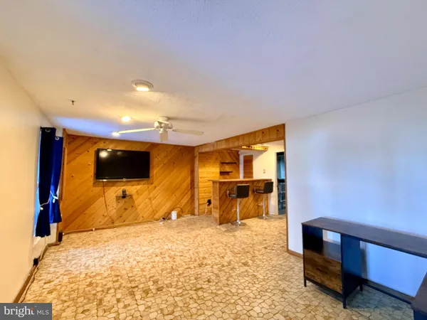 a bedroom with furniture and a flat screen tv