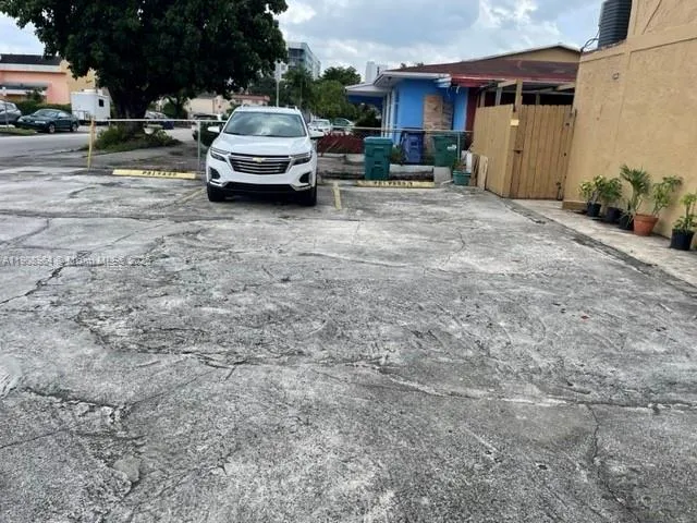 a white car parked in front of a building