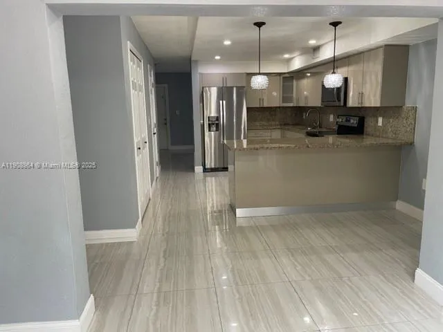a view of a room with wooden floor and window