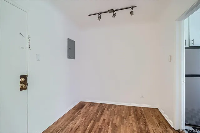 a view of a room with wooden floor and fan
