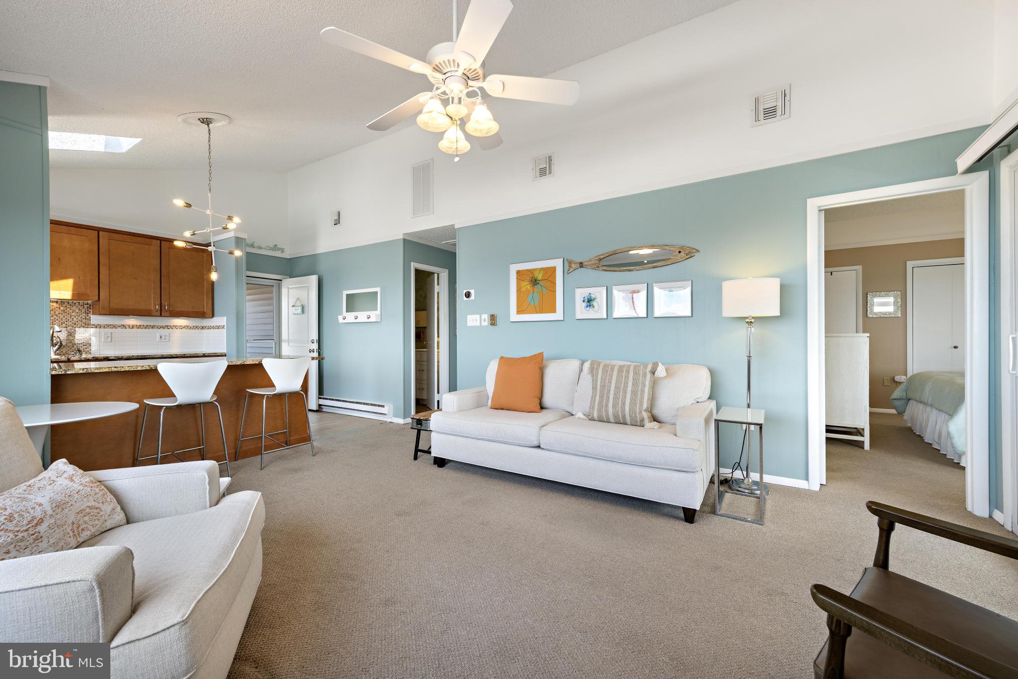 24 Joan Road Long Beach Township, NJ 08008 - Photo 7 of 55 a living room with furniture kitchen view and a chandelier