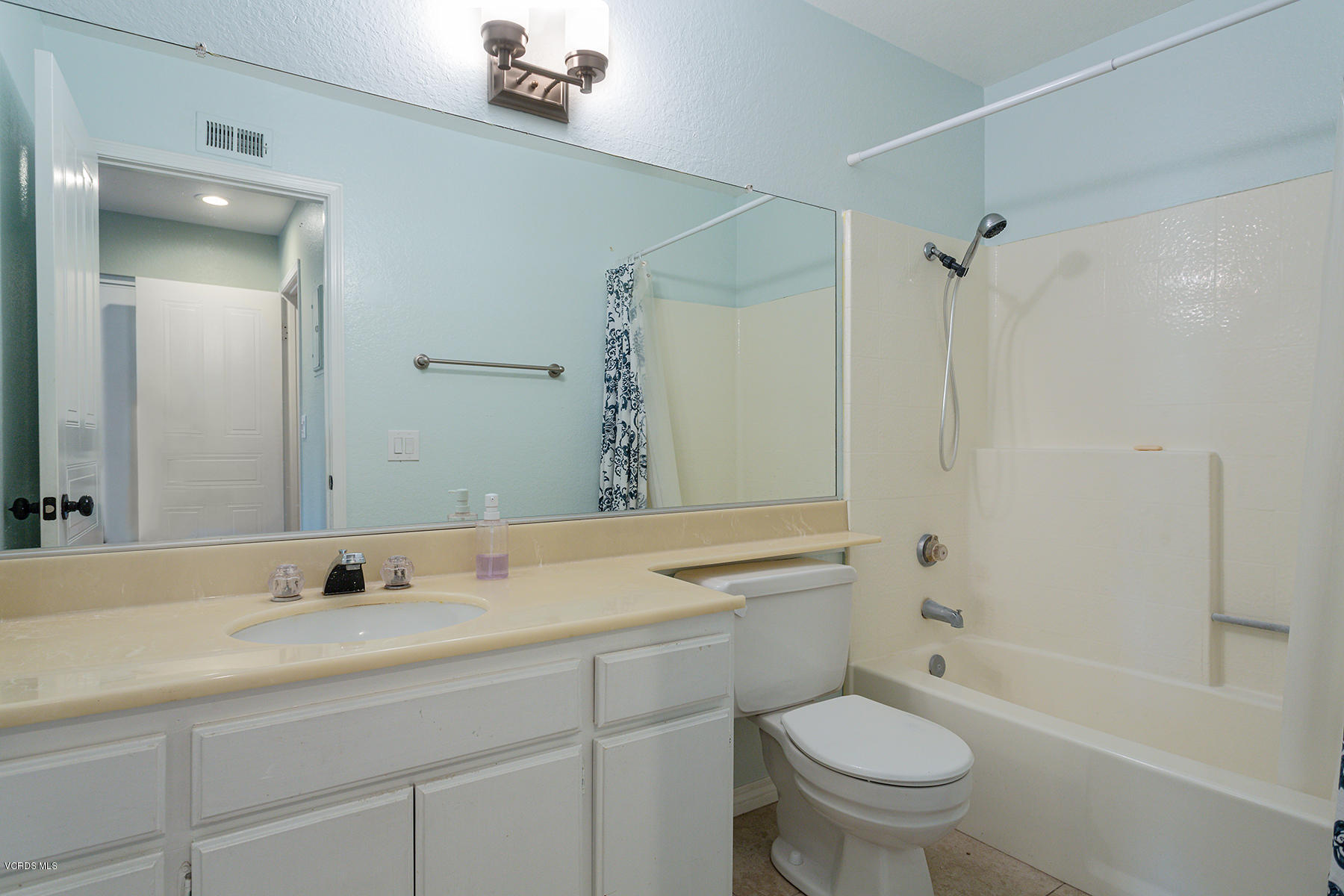 1818 Rory Lane, Unit 4 Simi Valley, CA 93063 - Photo 22 of 26 a bathroom with a sink toilet vanity granite shower and a mirror