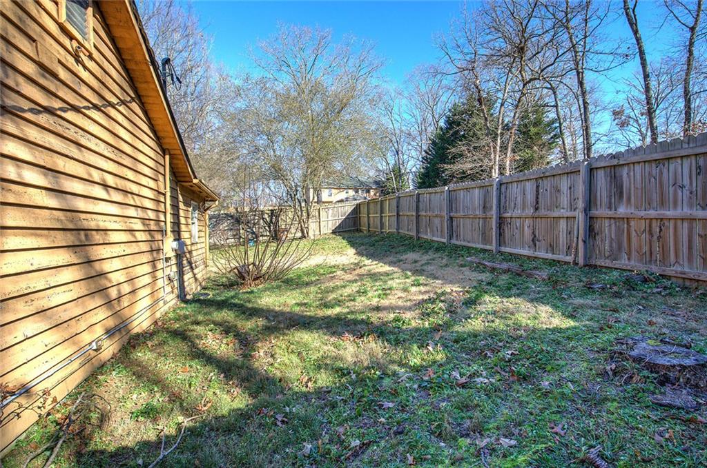 101 Ivy Lane Southeast Cartersville, GA 30121 - Photo 13 of 47 a view of backyard with wooden fence and trees