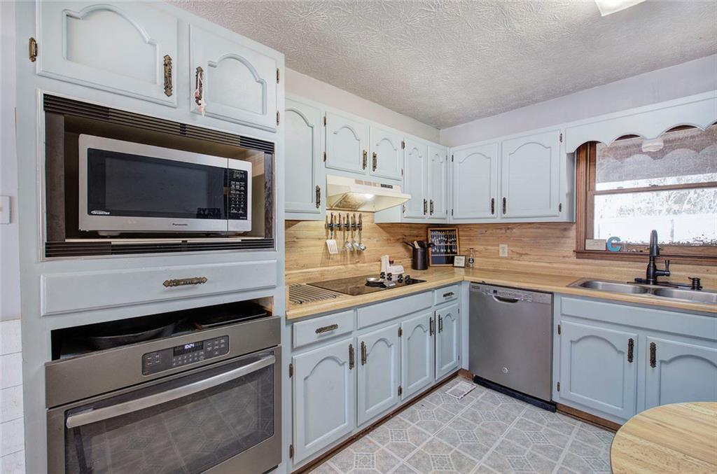 101 Ivy Lane Southeast Cartersville, GA 30121 - Photo 25 of 47 a kitchen with cabinets stainless steel appliances and a sink