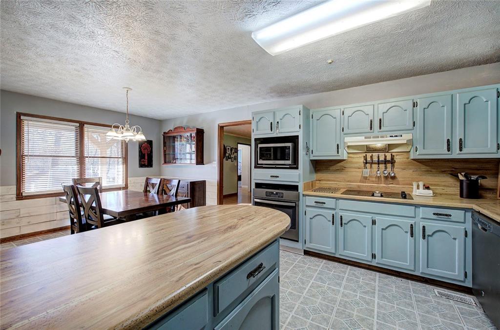 101 Ivy Lane Southeast Cartersville, GA 30121 - Photo 28 of 47 a kitchen with stainless steel appliances granite countertop a lot of counter space and wooden floors