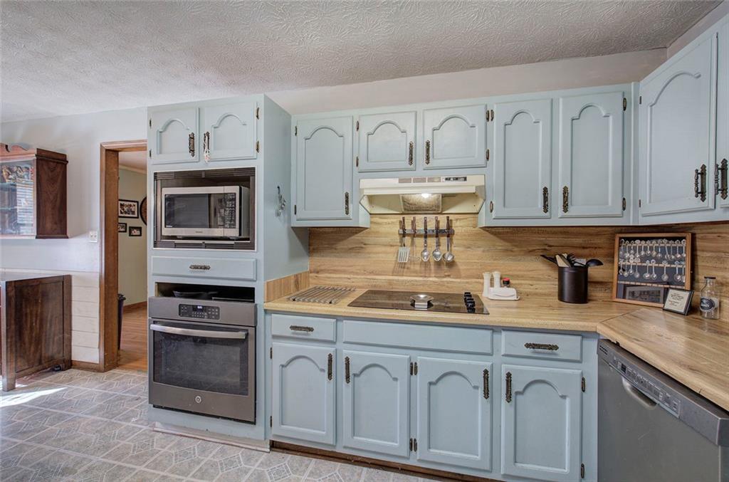 101 Ivy Lane Southeast Cartersville, GA 30121 - Photo 30 of 47 a kitchen with granite countertop white cabinets and stainless steel appliances