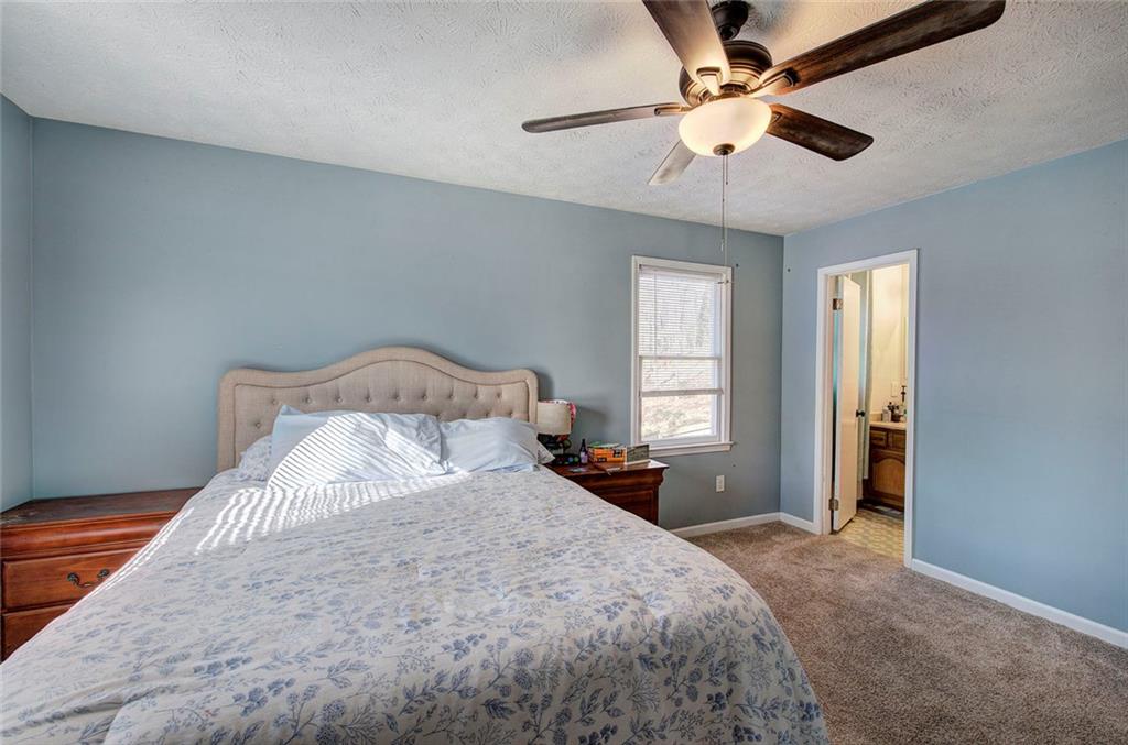 101 Ivy Lane Southeast Cartersville, GA 30121 - Photo 31 of 47 a bedroom with a large bed and a ceiling fan