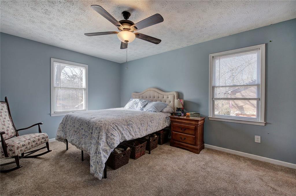 101 Ivy Lane Southeast Cartersville, GA 30121 - Photo 33 of 47 a bedroom with a bed and a chandelier