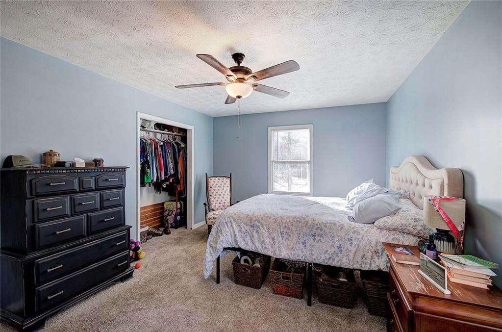 101 Ivy Lane Southeast Cartersville, GA 30121 - Photo 34 of 47 a bedroom with a bed and a chandelier