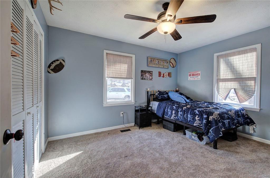 101 Ivy Lane Southeast Cartersville, GA 30121 - Photo 35 of 47 a bedroom with a bed chandelier and window