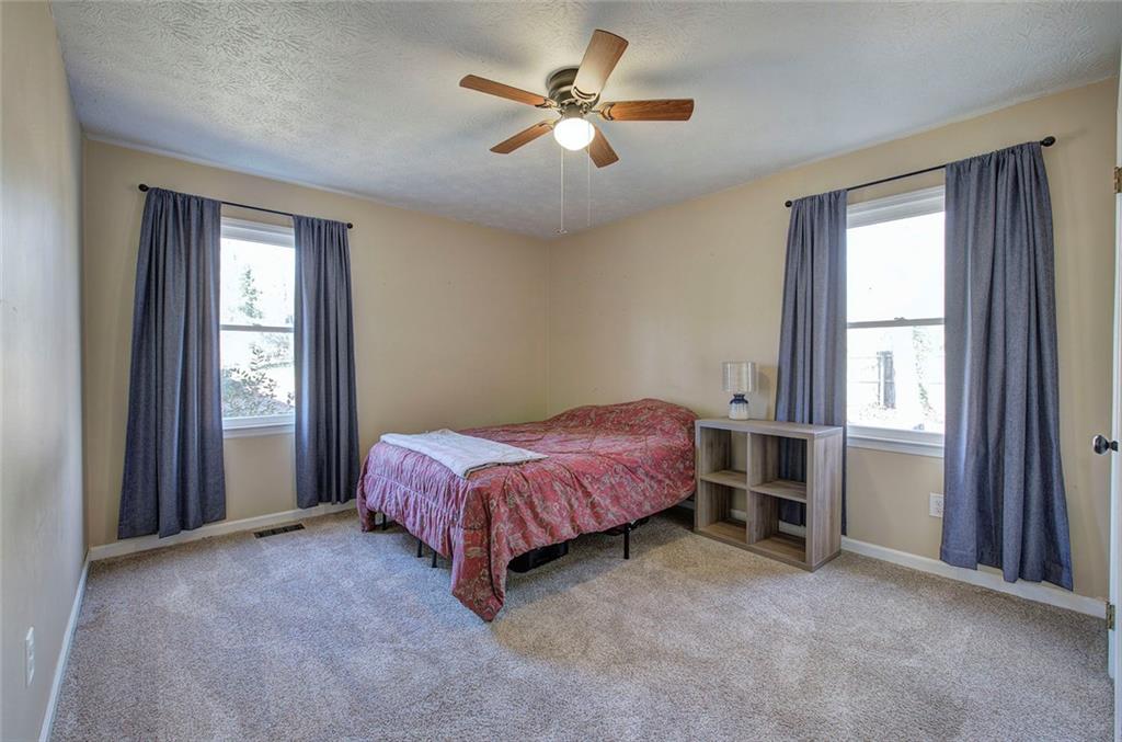 101 Ivy Lane Southeast Cartersville, GA 30121 - Photo 37 of 47 a spacious bedroom with a bed and a window