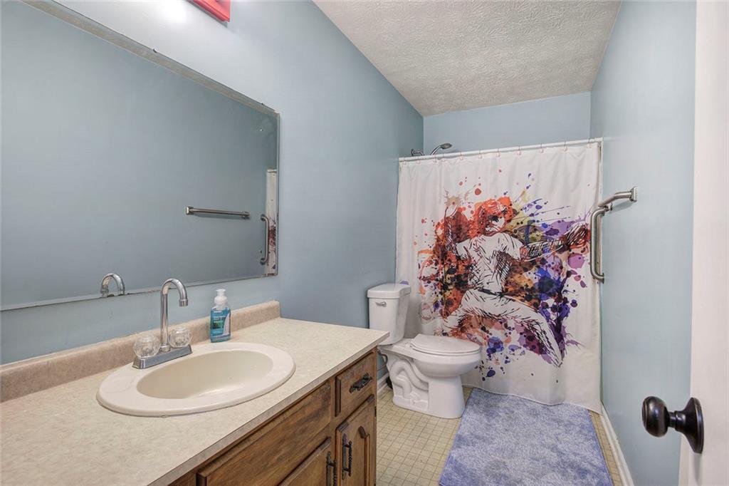 101 Ivy Lane Southeast Cartersville, GA 30121 - Photo 40 of 47 a bathroom with a sink mirror vanity and toilet