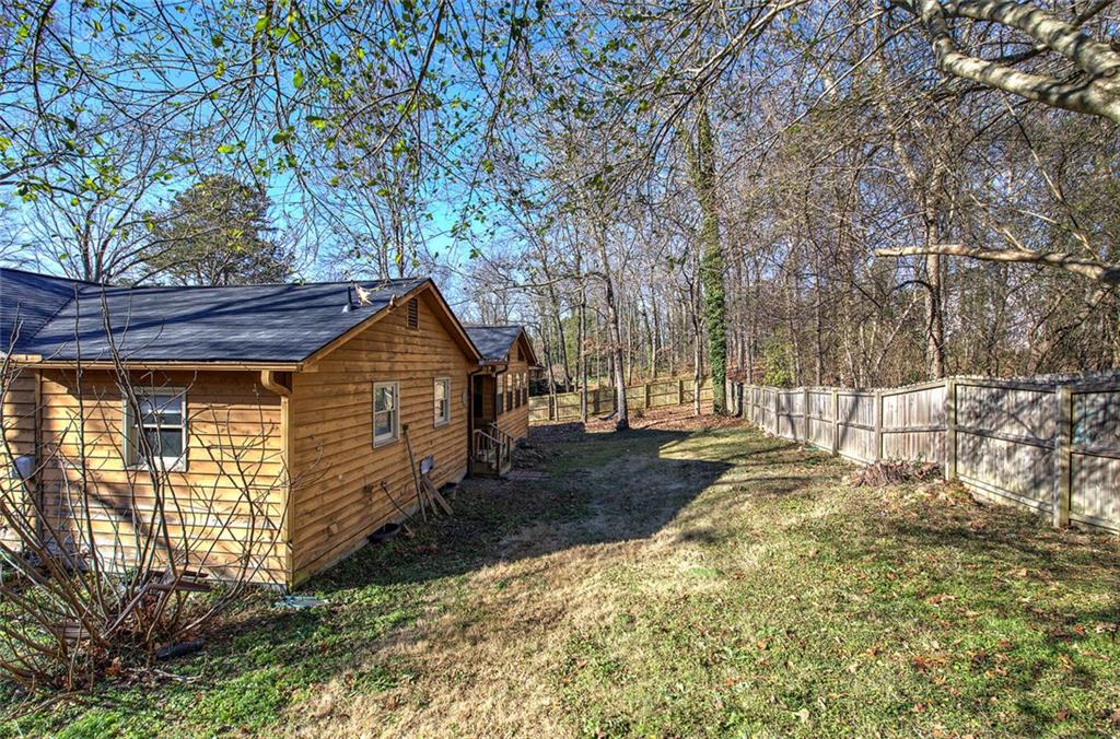 101 Ivy Lane Southeast Cartersville, GA 30121 - Photo 10 of 47 a view of a house with backyard and trees
