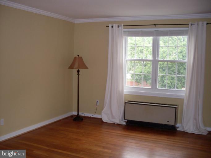 205 East Glebe Road, Unit 6205E Alexandria, VA 22305 - Photo 6 of 13 a view of empty room with wooden floor and fan