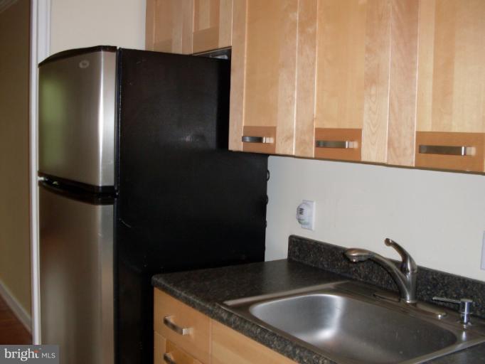 205 East Glebe Road, Unit 6205E Alexandria, VA 22305 - Photo 7 of 13 a kitchen with a sink and a refrigerator