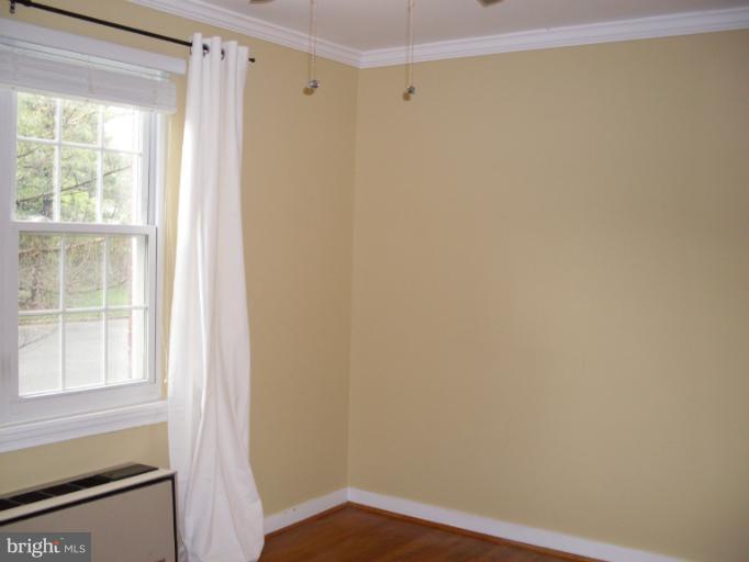 205 East Glebe Road, Unit 6205E Alexandria, VA 22305 - Photo 9 of 13 a view of a small space with wooden floor and a window
