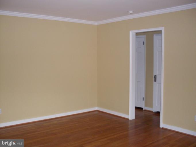 205 East Glebe Road, Unit 6205E Alexandria, VA 22305 - Photo 10 of 13 a view of an empty room with wooden floor
