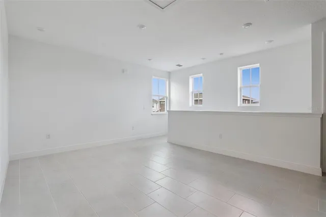 an empty room with a kitchen and a window
