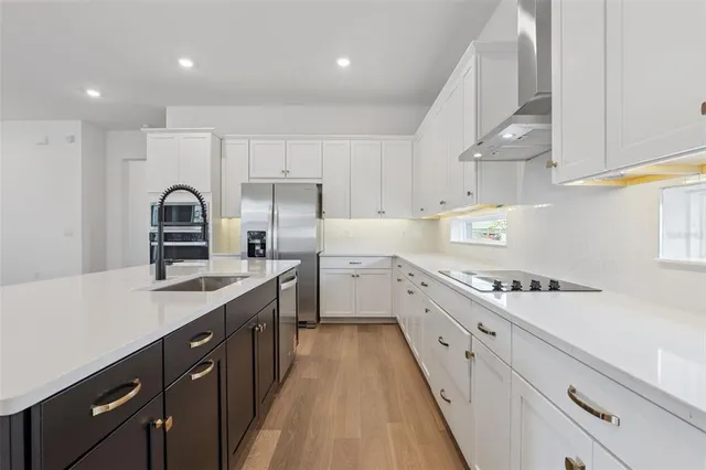a kitchen with cabinets a sink and appliances