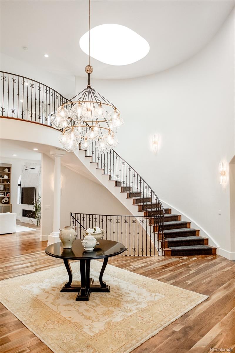 80 South Eudora Street Denver, CO 80246 - Photo 20 of 43 a view of staircase with a dining table chairs and a chandelier