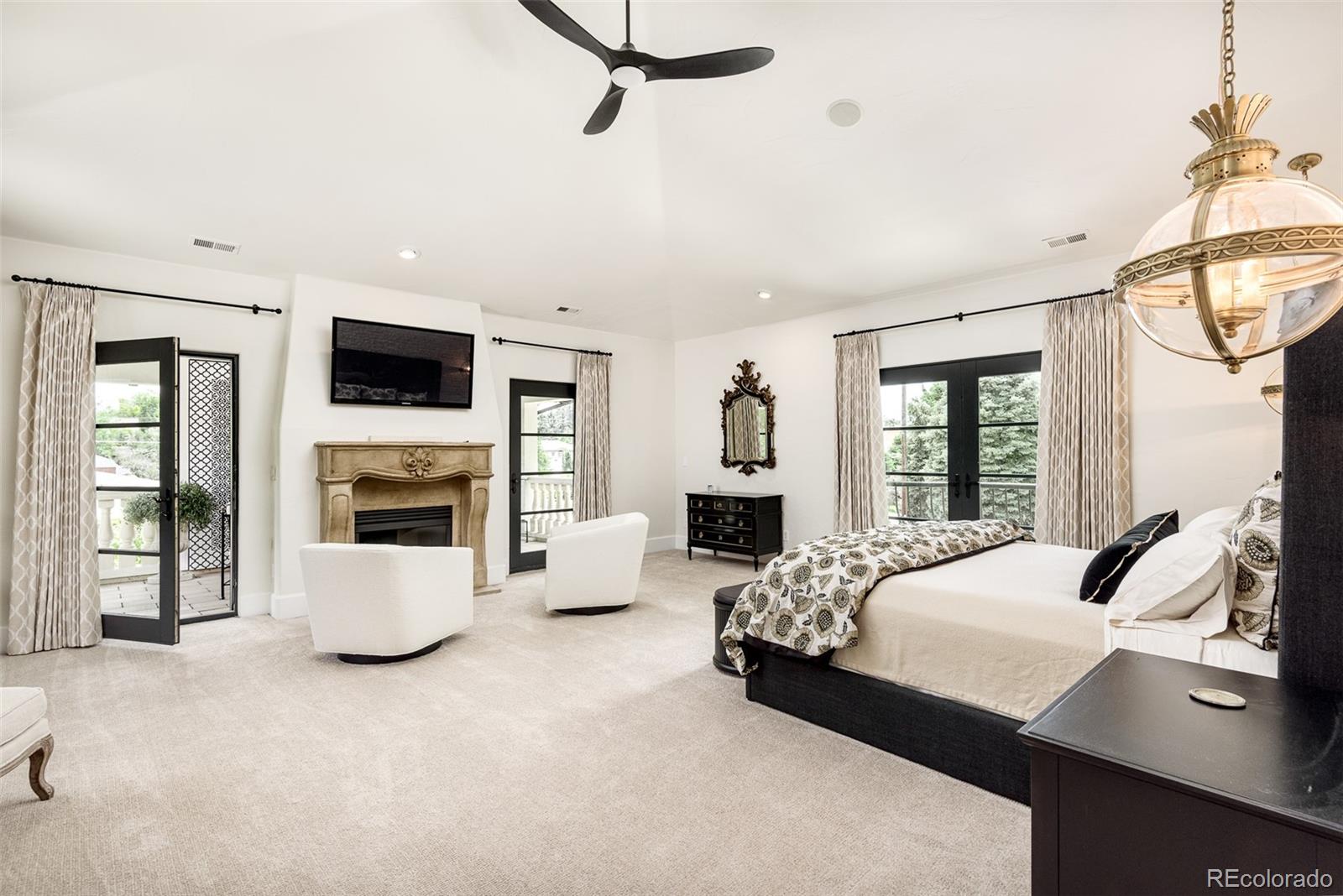 80 South Eudora Street Denver, CO 80246 - Photo 21 of 43 a bedroom with a bed couch and fireplace