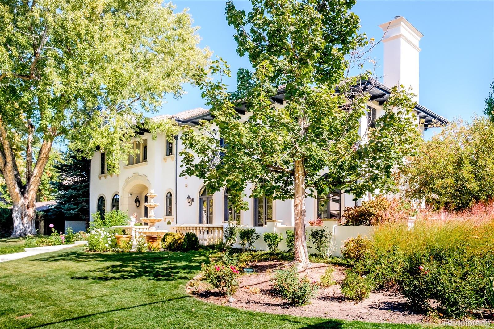 80 South Eudora Street Denver, CO 80246 - Photo 40 of 43 a view of a white house with a big yard and large trees