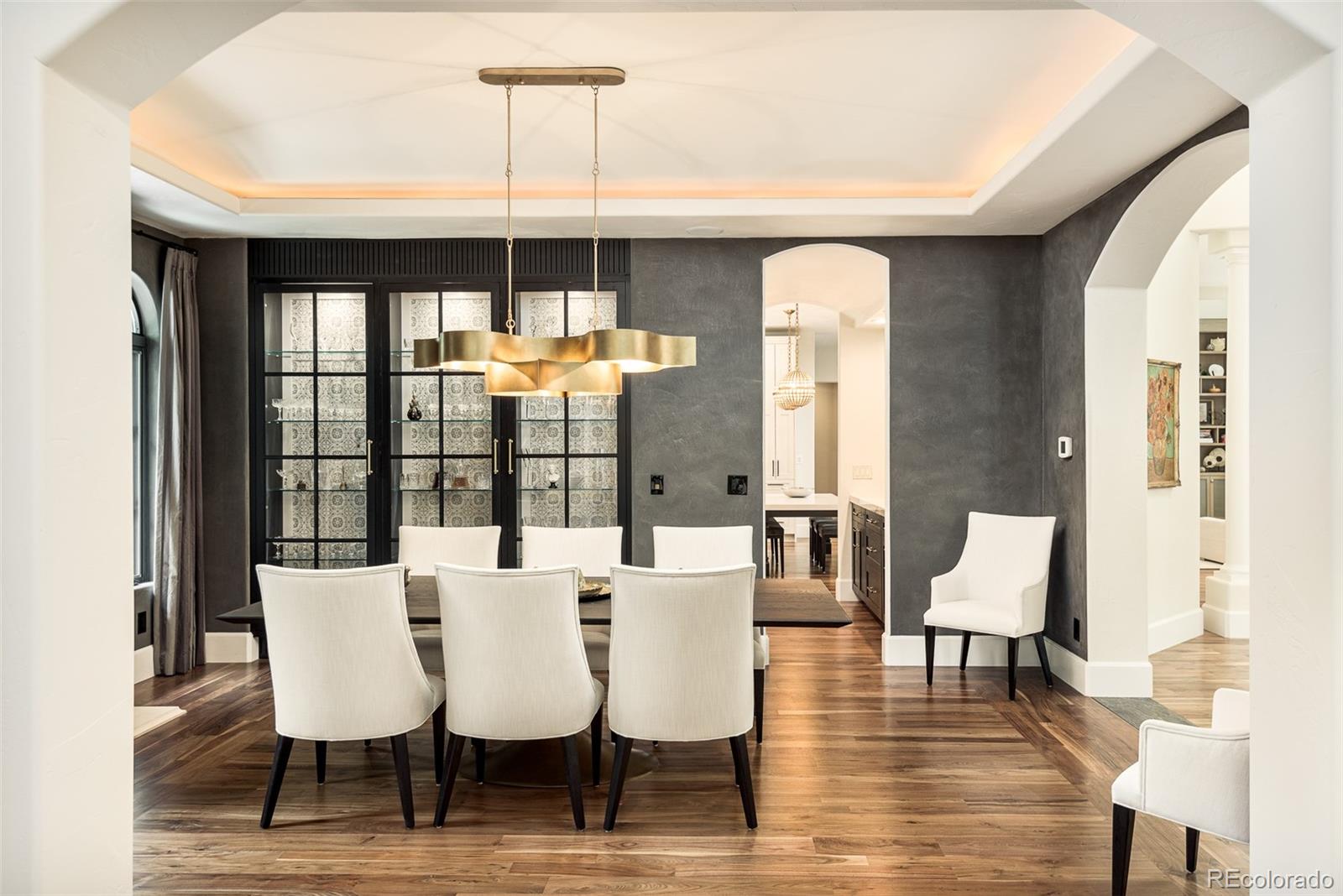 80 South Eudora Street Denver, CO 80246 - Photo 9 of 43 a dining room with furniture a chandelier and wooden floor