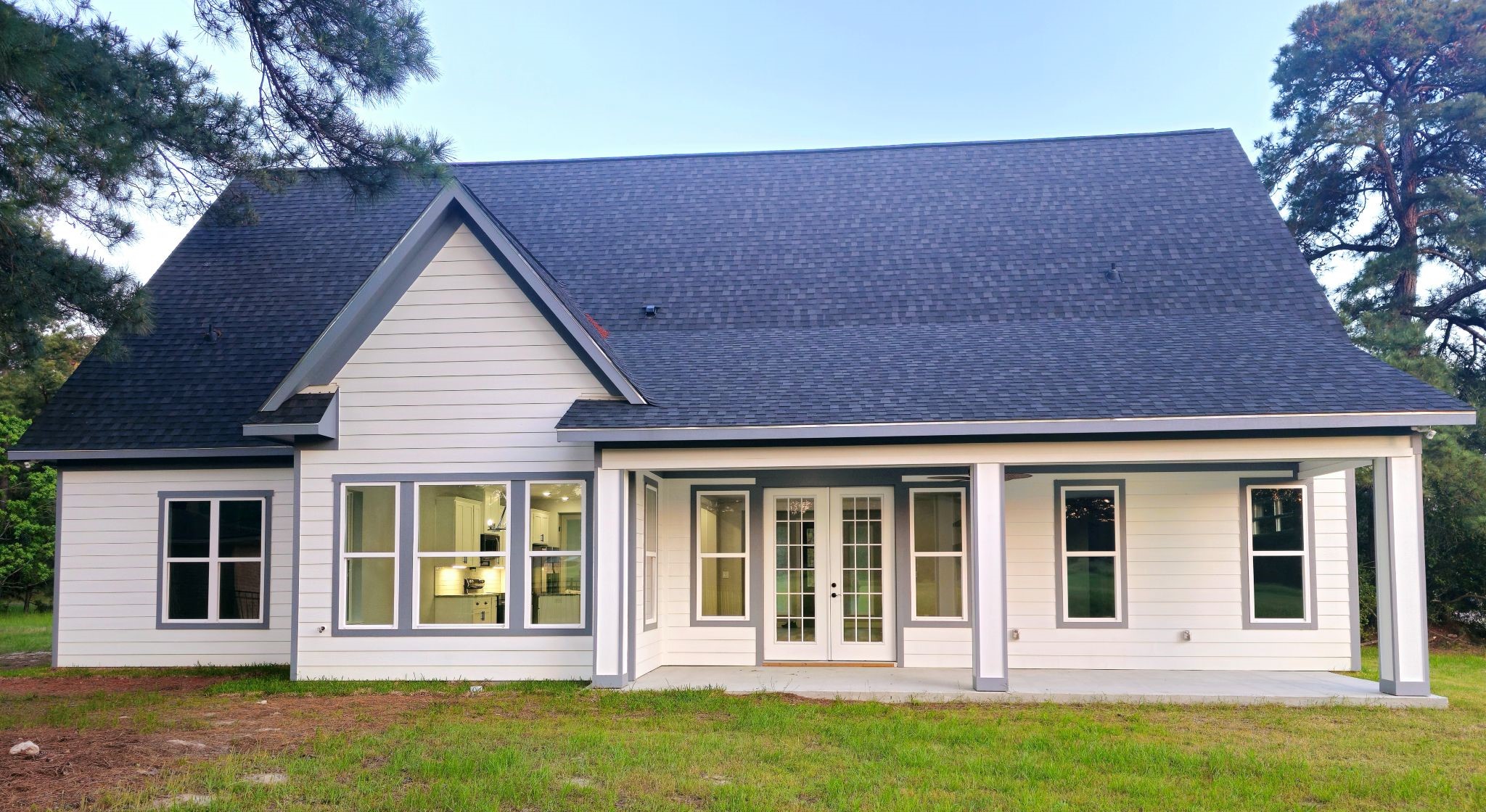 20 Lazy Springs Trinity, TX 75862 - Photo 37 of 37 Modern exterior, gabled roof, spacious covered patio, and large windows.
