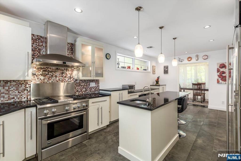65 Lincoln Avenue Rutherford, NJ 07070 - Photo 13 of 39 a kitchen with a stove and a chandelier