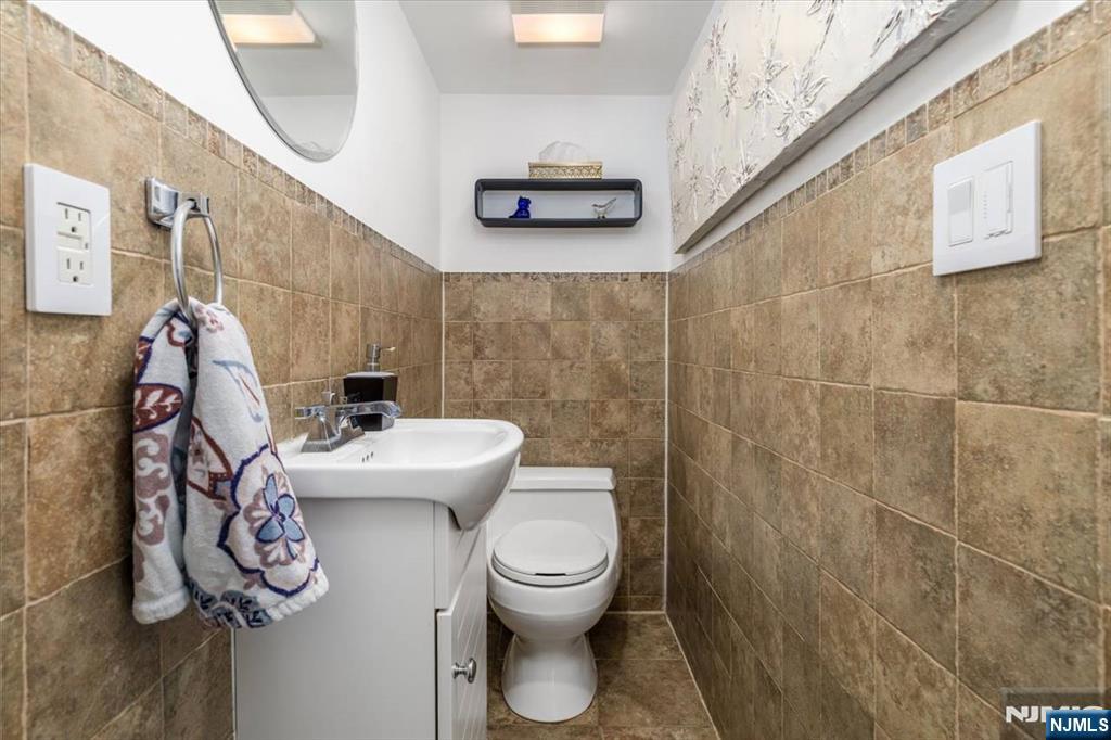 65 Lincoln Avenue Rutherford, NJ 07070 - Photo 15 of 39 a bathroom with a toilet and a mirror