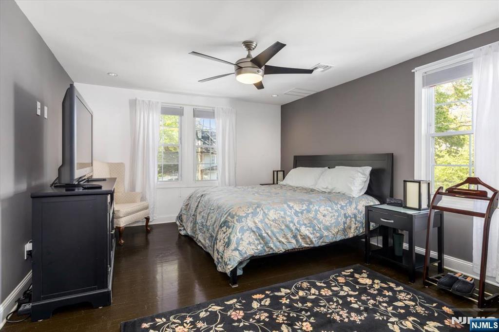 65 Lincoln Avenue Rutherford, NJ 07070 - Photo 19 of 39 a bedroom with a bed and a chandelier