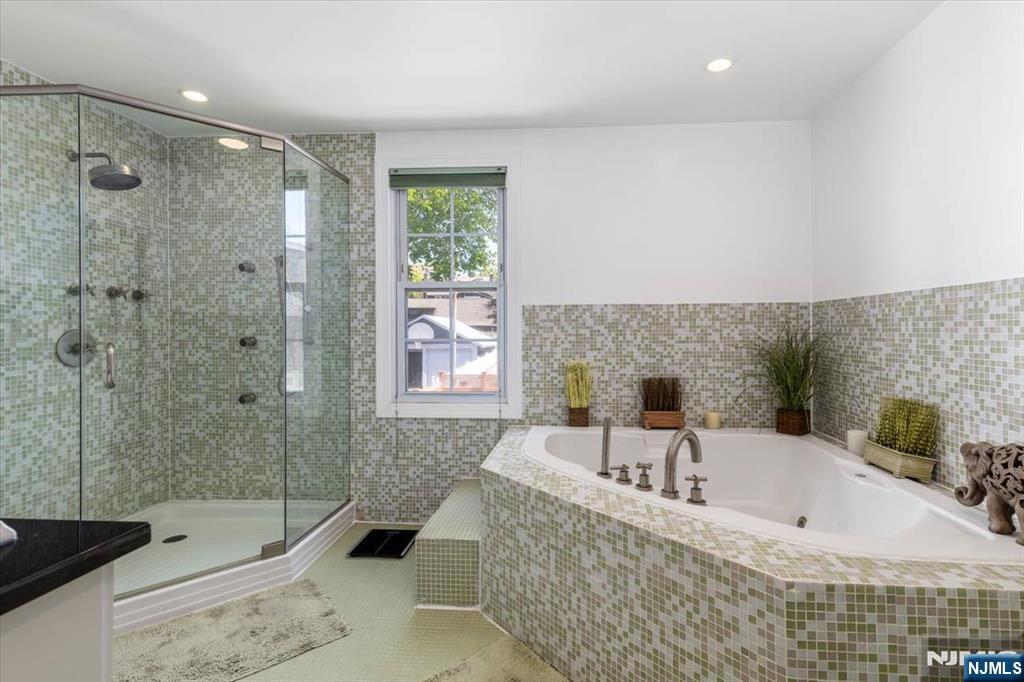 65 Lincoln Avenue Rutherford, NJ 07070 - Photo 22 of 39 a bathroom with a tub sink and shower