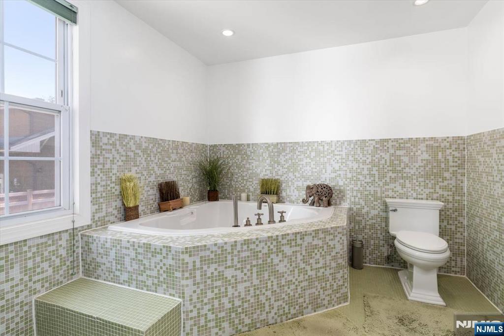 65 Lincoln Avenue Rutherford, NJ 07070 - Photo 23 of 39 a bathroom with a sink a toilet and mirror