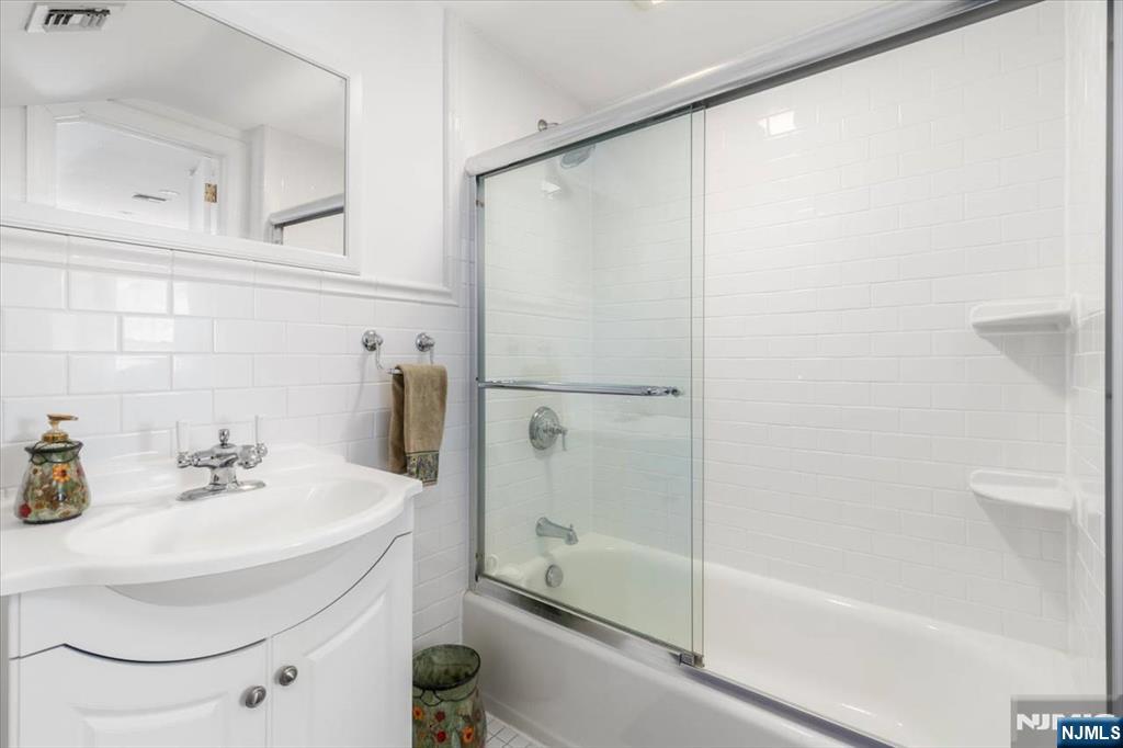 65 Lincoln Avenue Rutherford, NJ 07070 - Photo 30 of 39 a bathroom with a sink and a mirror