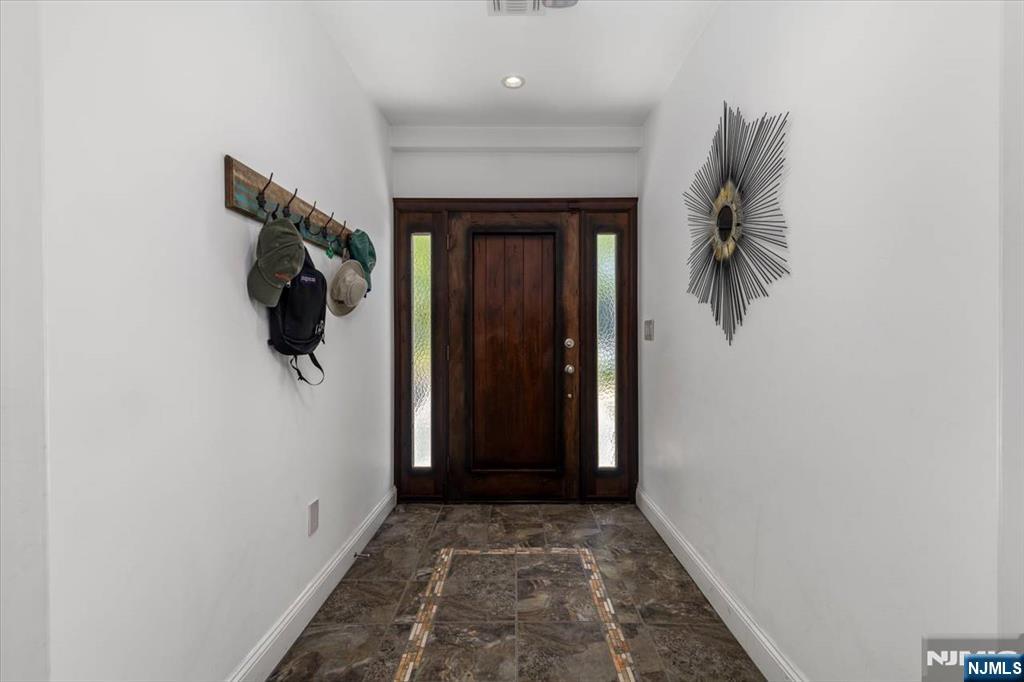 65 Lincoln Avenue Rutherford, NJ 07070 - Photo 3 of 39 a view of a hallway with wooden floor and a window