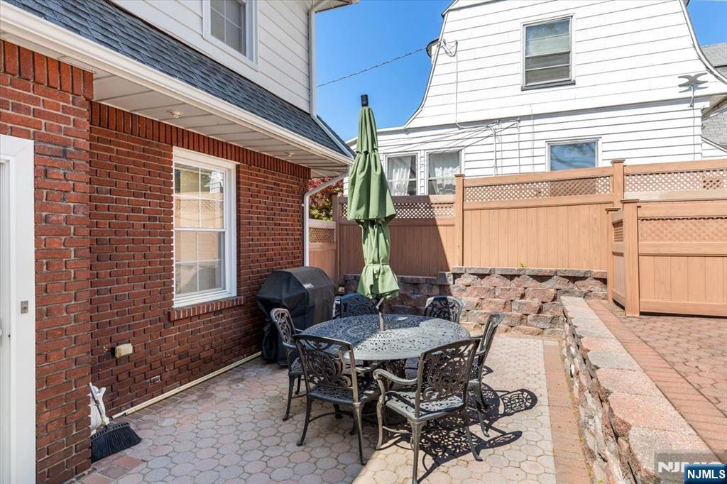 65 Lincoln Avenue Rutherford, NJ 07070 - Photo 33 of 39 a view of a patio with table and chairs and potted plants