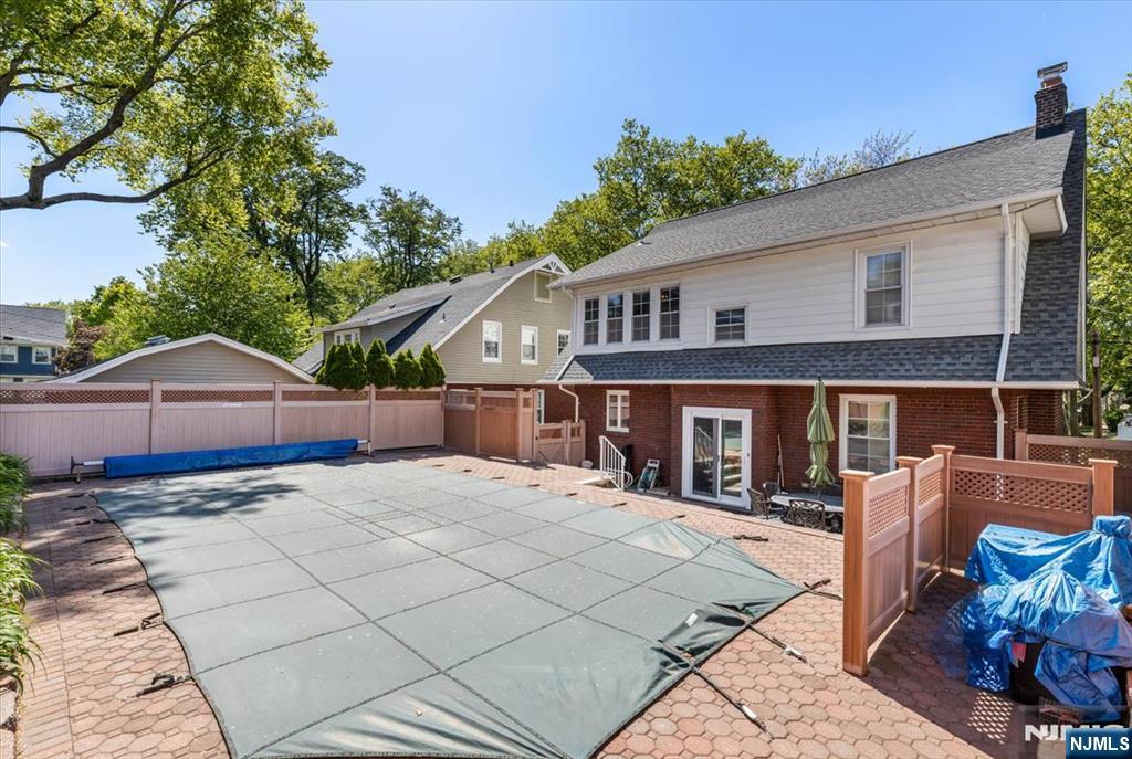 65 Lincoln Avenue Rutherford, NJ 07070 - Photo 35 of 39 a patio with a table and chairs under an umbrella