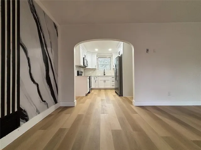 a view of a living room washer and dryer with wooden floor
