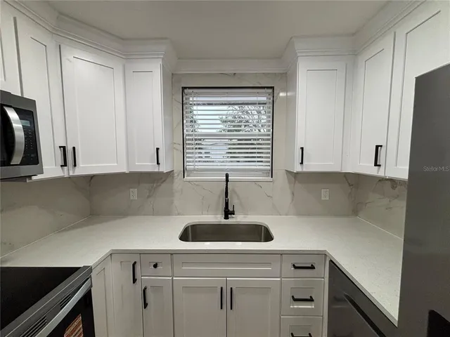a kitchen with a sink and cabinets