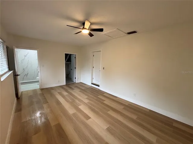 a view of empty room with ceiling fan