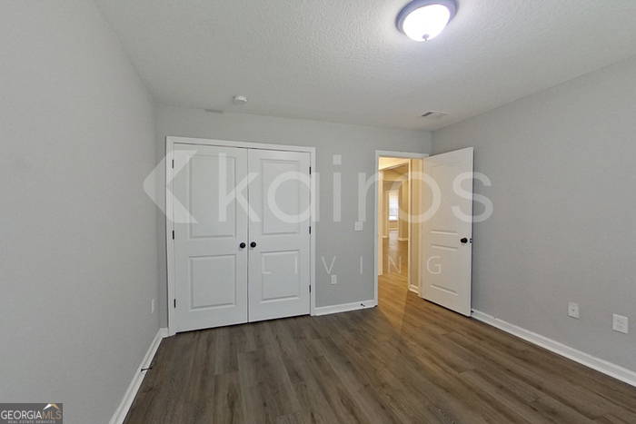 132 Cottage Grove Road Brunswick, GA 31525 - Photo 7 of 17 a view of an empty room with wooden floor