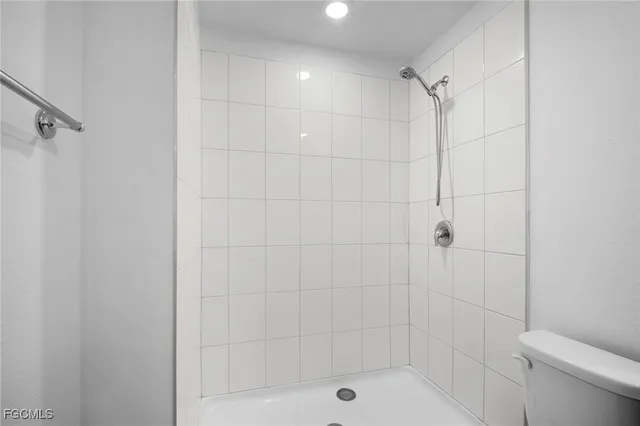 a bathroom with a shower and toilet