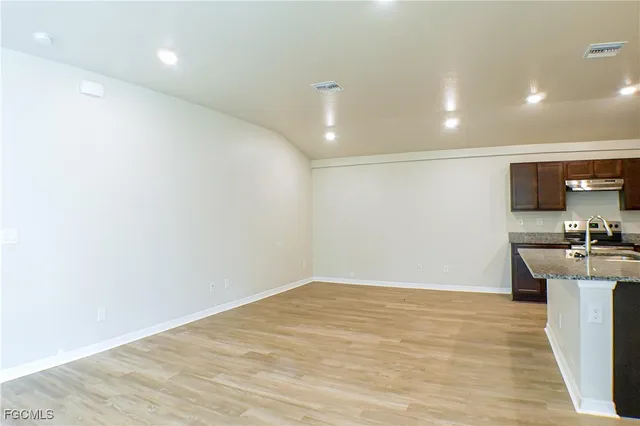 a view of a kitchen with microwave and cabinets