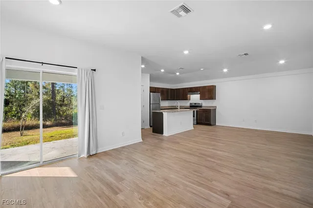 a view of a kitchen with a sink and a stove top oven